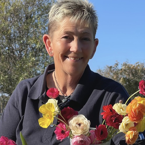 Theresa Matthews with a handful of colorful ranunculus blooms