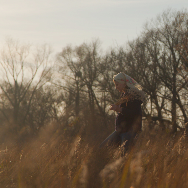 Alla Olkhovska walking through a field in Kharkiv, Ukraine